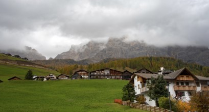 Costadedoi, Italy, October 19 2019: Traditional wooden cottage mountain houses in the green field