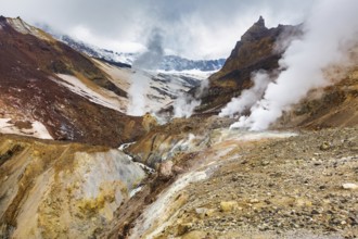 Majestic mountain landscape, crater of active volcano: hot spring and fumarole activity, lava plain