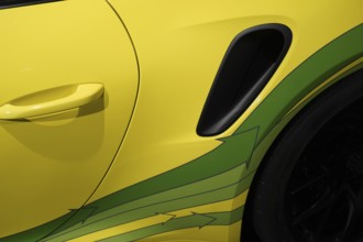 Close-up detail of the yellow-green paintwork and ventilation of a car, exhibition, Neues