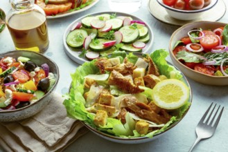 Fresh salads, an assortment. Variety of plates and bowls with green vegetables. Healthy food.