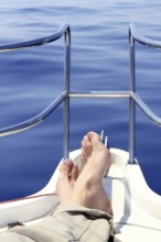 Boat bow man feet blue sea view sailing ocean relaxed calm saltwater