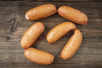 Smoked sausages on dark rustic wooden background