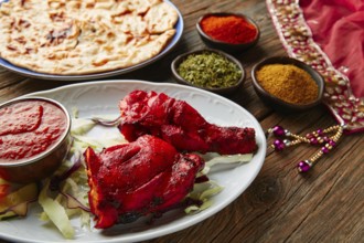 Chicken Tandoori indian recipe with spices on wood