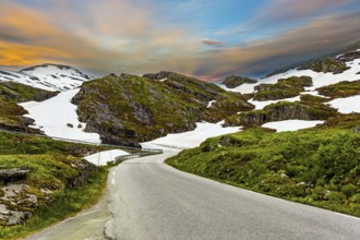 The road to Lake Djupvatnet. The mountains are covered with freshly fallen snow. Summer trip to