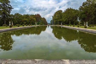 France. Thepossession of Puss in Boots. Huge rectangular swimming pool with a fountain in the park.