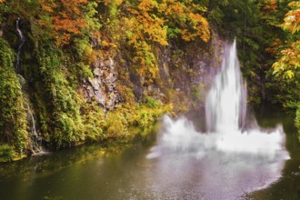 Dancing fountain in a quiet pond. Autumn day in the park. Butchart Gardens on Vancouver Island,