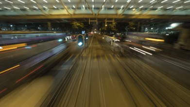 View to the road and transport from moving double-decker train. Shot in motion, Hong Kong, Asia