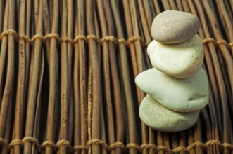 Stacked stones on wooden base. Studio shot