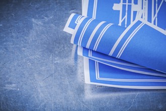 Blue construction plans on metallic background