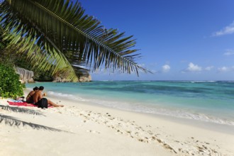 Couple on the beach Anse Source a Jean, Union Estate National Park, La Digue Island, the