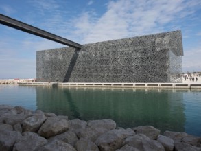 Metal decorated modern building in a watery environment under a blue sky, marseille, mediterranean