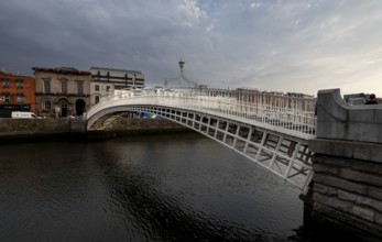 Dublin, Ireland, UK, June 19, 2022: Famous landmark of Ha' penny bridge over the river liffey