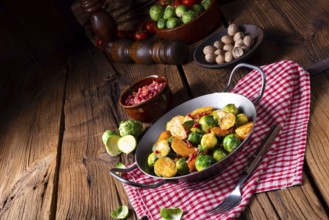 Brussels sprouts potato pan with bacon in a rustic style