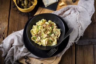 Reginette pasta in cream sauce with fresh chanterelles and capers