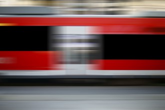 The abstract motion strips of a passing express train at a railway station