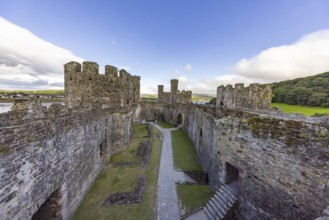 Medieval castle with high stone walls and towers under a blue sky