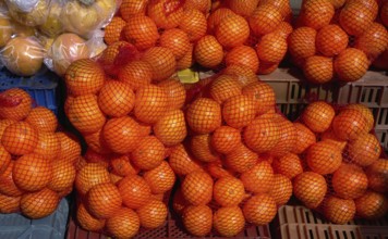 Oranges from Mediterranean in net bags at the outdoor market