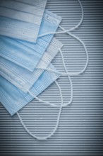 Set of medical disposable face masks on striped background