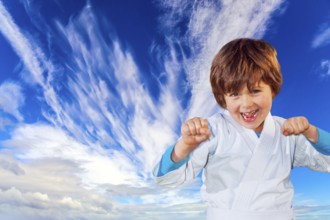 Concept - photo advertising, children, sports. Boy in a white kimono practices judo. Background -