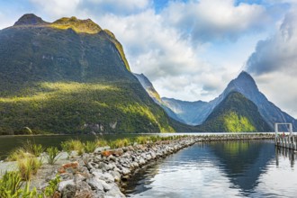 The mountains are reflected in the smooth water of the fjord. The most famous and picturesque fjord