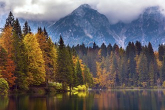 Lake Fuzine. Grand mountain range Dolomite Alps in thunderclouds. Border between Italy and Slovenia