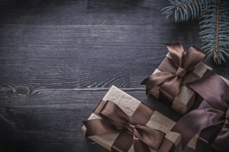 Pine branch packed present box on wooden board holiday concept