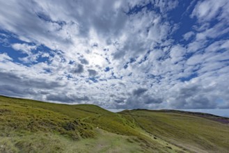 Vast rolling countryside with green meadows and sea views on the edge of Snowdonia National Park,