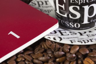 Coffee beans, cup of coffe and diary for January