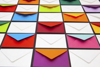 Composition with white and colored envelopes on the table. The photo suitable for various holidays