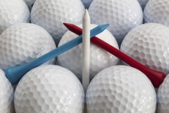 White golf balls and different tees