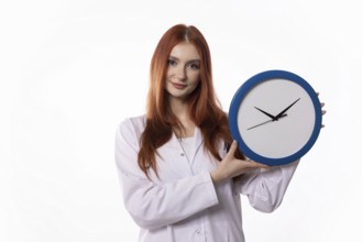 A young woman wearing a lab coat is showcasing a clock, which symbolizes the importance of