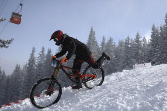 Sofia, Bulgaria - 22 January, 2022: Cyclist rides a bike downhill during an extreme snow riding