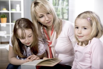 Young family at reading in the flat