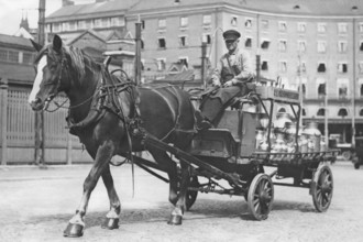 In the 1930s. A horse and carriage pictures in a Stockholm street 1936. The horse-drawn cart has a