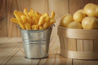 Potato Fries And Whole Potato On Wood Background