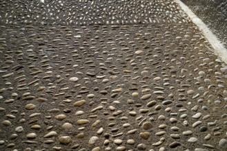 Altea soil rolling stone mosaic on flooring of Alicante Spain