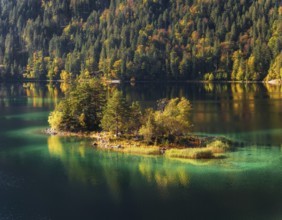 Lake Eibsee with a small island near mountain Zugspitze in south germany in fall