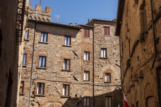 Facade of beautiful residential houses in the center of Volterra, Italy, Europe