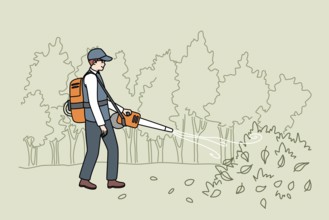 Male gardener in uniform collection leaves with handy vacuum. Man handyman working outdoors in