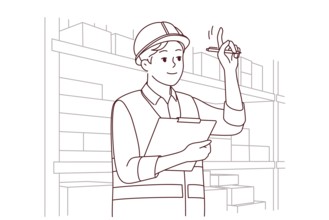Man in uniform and helmet working in warehouse. Smiling male engineer or mechanic at storehouse or
