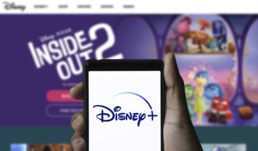 Smartphone with Disney+ logo displayed on the screen.