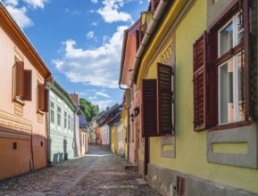 Beautiful Transylvanian street on a sunny summer day in Sighisoara, Romania, Europe
