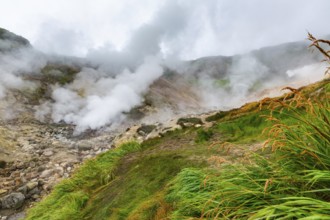 Thrilling view of volcanic landscape, aggressive hot spring, erupting fumarole, gas-steam activity