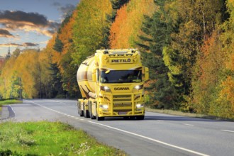 Beautifully customized yellow brown Nextgen Scania tank truck for bulk transport on Highway 10 on a