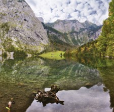 Cloudy day on the lake. Magic reflection in German lake Koenigssee. Clouds and mountains reflected