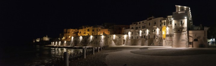 Beautifully illuminated city wall at the coast of Vieste in Gargano, Italy, Europe