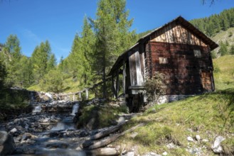 An old wooden watermill in Val di Morins, the Dolomite Alps of South Tirol