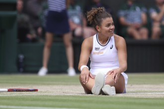 Italian tennis player Jasmine Paolini sitting on the ground after a fall at the 2024 Wimbledon