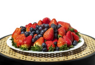 Three kinds of fresh berries on a white plate, on white background
