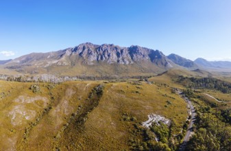 An aerial view of Gordon River Rd at the Sentinel range of mountains near Bitumen Bones Sculpture